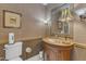 Elegant powder room with a decorative mirror, wallpaper, and classic vanity at 131 Long Shadow Ln, Cary, NC 27518