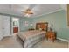 Cozy bedroom with a wooden bed frame, side tables, and a ceiling fan for comfortable living at 131 Long Shadow Ln, Cary, NC 27518