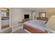 Spacious bedroom featuring a king bed, dresser and TV cabinet at 131 Long Shadow Ln, Cary, NC 27518