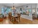Dining room with wood floors, natural light, and open access to the living room at 131 Long Shadow Ln, Cary, NC 27518