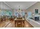 Dining room with hardwood floors, chandelier, and a mirror feature wall at 131 Long Shadow Ln, Cary, NC 27518