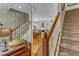 Entryway featuring wood floors and staircase leading to a spacious, light-filled living area at 131 Long Shadow Ln, Cary, NC 27518