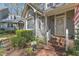 Beautifully landscaped gray townhome with white trim and brick walkway at 131 Long Shadow Ln, Cary, NC 27518