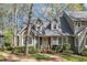 Charming home featuring a brick walkway, dormer windows, and well-maintained landscaping at 131 Long Shadow Ln, Cary, NC 27518