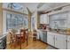 Charming kitchen featuring stainless steel dishwasher and an adjacent dining area at 131 Long Shadow Ln, Cary, NC 27518