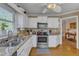Kitchen with white cabinetry, stainless steel appliances, and adjacent dining area at 131 Long Shadow Ln, Cary, NC 27518