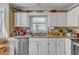 Charming kitchen with white cabinets, granite countertops, and stainless steel appliances at 131 Long Shadow Ln, Cary, NC 27518