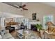 Inviting living room with a fireplace, ceiling fan, and lots of natural light at 131 Long Shadow Ln, Cary, NC 27518