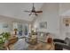 Bright living room with a ceiling fan and French doors leading to a balcony at 131 Long Shadow Ln, Cary, NC 27518
