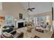 Inviting living room with fireplace, vaulted ceiling, and access to outdoor patio at 131 Long Shadow Ln, Cary, NC 27518