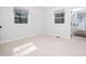 Well-lit bedroom features neutral carpet, two windows, and white trim at 1402 Valley Rd, Garner, NC 27529