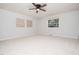 Bright, spacious bedroom with neutral carpet, ceiling fan, and a window offering ample natural light at 1402 Valley Rd, Garner, NC 27529