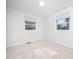 Bright bedroom features neutral carpet and two windows at 1402 Valley Rd, Garner, NC 27529