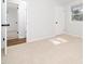 Bright bedroom with neutral carpet, white walls, window, and closet at 1402 Valley Rd, Garner, NC 27529