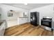 Kitchen featuring stainless steel oven and fridge, wood floors and breakfast bar at 1402 Valley Rd, Garner, NC 27529