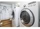 Convenient laundry room featuring modern washer and dryer with updated flooring at 1402 Valley Rd, Garner, NC 27529