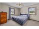 Cozy bedroom featuring a comfortable bed, two windows, and a wooden dresser at 1507 Ridgeway Ave, Durham, NC 27701