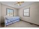 Bright bedroom featuring natural light, a cozy bed, and a ceiling fan at 1507 Ridgeway Ave, Durham, NC 27701