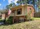 A charming two-story brick home featuring classic architecture, an American flag and well-maintained landscaping at 1507 Ridgeway Ave, Durham, NC 27701