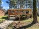 Charming brick home with a split-level design, garage, and landscaped front yard at 1507 Ridgeway Ave, Durham, NC 27701