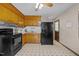 Functional kitchen featuring wood cabinets and black appliances at 1507 Ridgeway Ave, Durham, NC 27701