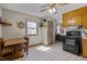 Kitchen/dining combo with wood cabinets, vintage linoleum, and window light at 1507 Ridgeway Ave, Durham, NC 27701