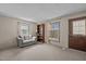 Comfortable living room with neutral carpet, sofa and bookshelf at 1507 Ridgeway Ave, Durham, NC 27701