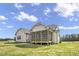 Rear exterior view of a house with a screened porch and open backyard at 151 S Harper Faith Way, Benson, NC 27504