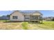 Rear exterior view of a home with a screened porch and spacious backyard at 151 S Harper Faith Way, Benson, NC 27504
