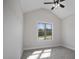 Bright bedroom featuring a vaulted ceiling, neutral walls, plush carpet, and a large window at 151 S Harper Faith Way, Benson, NC 27504