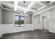 Bright dining room featuring coffered ceilings, wainscoting, dark floors, and natural light from a large window at 151 S Harper Faith Way, Benson, NC 27504