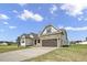 Charming two-story home featuring stone accents, a two-car garage, and a beautifully landscaped front yard at 151 S Harper Faith Way, Benson, NC 27504