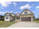 Inviting two-story home with stone details, a two-car garage, and a meticulously kept lawn at 151 S Harper Faith Way, Benson, NC 27504