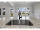 Kitchen island featuring granite countertop and stainless steel sink at 151 S Harper Faith Way, Benson, NC 27504