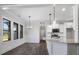 Open concept floor plan features kitchen with granite counters and wood floors at 151 S Harper Faith Way, Benson, NC 27504