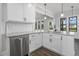 Updated kitchen featuring white cabinets, granite countertops, stainless appliances, and dark wood floors at 151 S Harper Faith Way, Benson, NC 27504