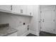 Laundry room featuring white cabinets, granite countertop and white walls at 151 S Harper Faith Way, Benson, NC 27504