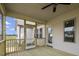 View of the screened in porch with wood flooring, ceiling fan, and entrance to the backyard at 151 S Harper Faith Way, Benson, NC 27504