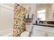 Charming bathroom featuring a patterned shower curtain, framed artwork, and neutral walls at 1515 Willbrook Dr, Fuquay Varina, NC 27526