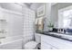 Clean bathroom featuring a shower-tub combo, neutral color palette, and modern fixtures at 1515 Willbrook Dr, Fuquay Varina, NC 27526