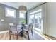 Dining area with views of outdoor patio features modern lighting, wood floors, and shiplap walls at 1515 Willbrook Dr, Fuquay Varina, NC 27526