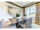 Bright dining area with an expansive window, modern table and statement decorations at 1515 Willbrook Dr, Fuquay Varina, NC 27526