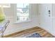 Welcoming entryway with wood floors, a white front door and a security features at 1515 Willbrook Dr, Fuquay Varina, NC 27526