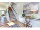 Bright entryway with hardwood floors, staircase, and decorative console table at 1515 Willbrook Dr, Fuquay Varina, NC 27526