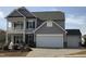 Two-story home featuring an attached garage, covered porch, and manicured landscaping at 1515 Willbrook Dr, Fuquay Varina, NC 27526