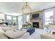 Open living room features a stone fireplace, neutral decor, and seamless access to the dining area at 1515 Willbrook Dr, Fuquay Varina, NC 27526