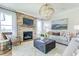 Cozy living room with stone fireplace, plush seating, and large windows for natural light at 1515 Willbrook Dr, Fuquay Varina, NC 27526