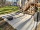 Spacious backyard with patio area, partial fence, and mature trees providing privacy at 182 Mill Bend Dr, Fuquay Varina, NC 27526