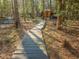 Wooden pathway through the backyard leads to the outdoor recreation area at 182 Mill Bend Dr, Fuquay Varina, NC 27526