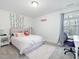 Comfortable bedroom with pink accents, plush rug, bed, desk, and natural light at 182 Mill Bend Dr, Fuquay Varina, NC 27526